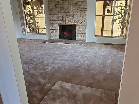 Entryway to Large Main Living/Family Room, High Beam Ceiling, Faux/Mock Fireplace, Ceiling Fan, Windows.