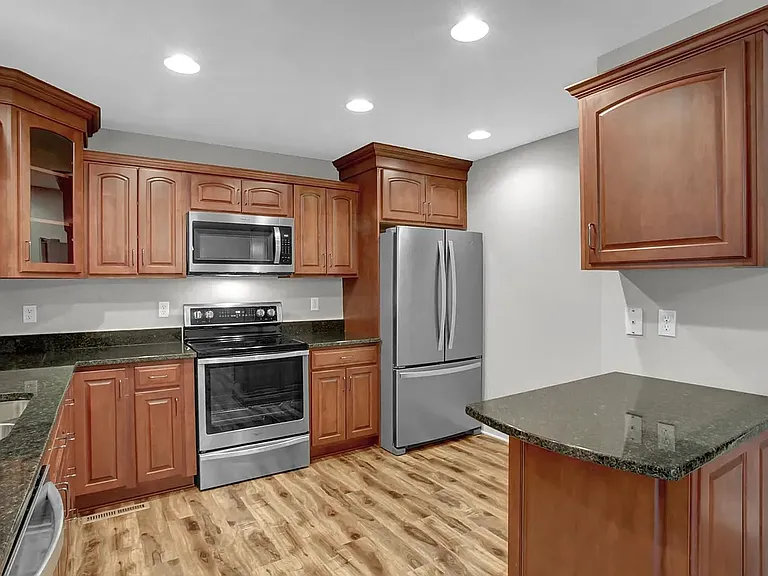 Granite, Stainless appliances and cherry cabinets