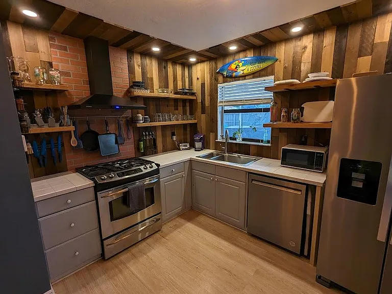 Large kitchen with custom shiplap backsplash and open shelves