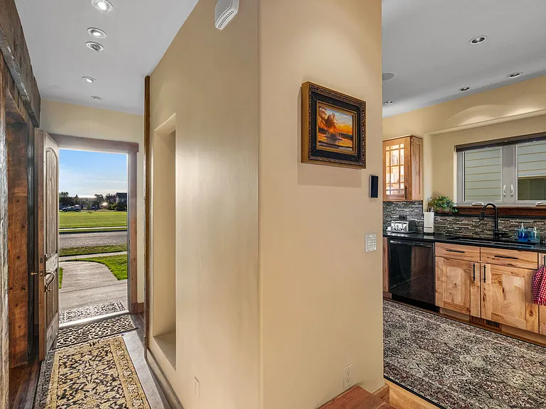 Reclaimed lumber lined entry with office and seating area. Front door opens to the park.
