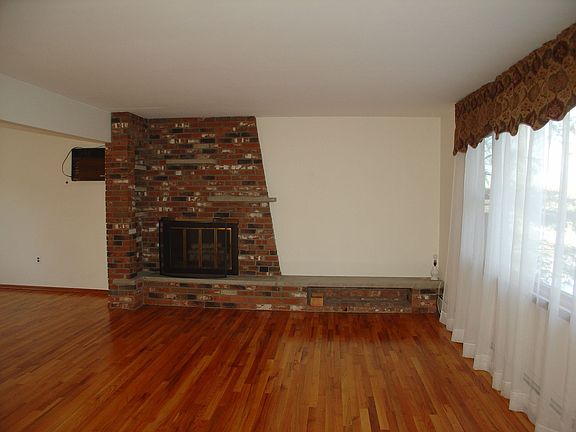 Custom Fireplace - Gleaming Hardwood Floors through out!