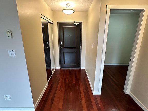 Main entry, hall closet, and door to the den.
