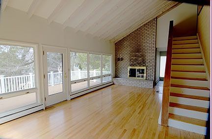 Living Room w/ cathedral ceiling and fireplace