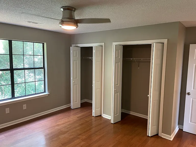 Double closets, a ceiling fan, and great light from the windows