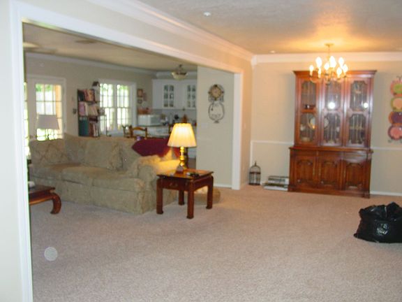 Open floor plan with neutral wall colors, crown molding & neutral carpet