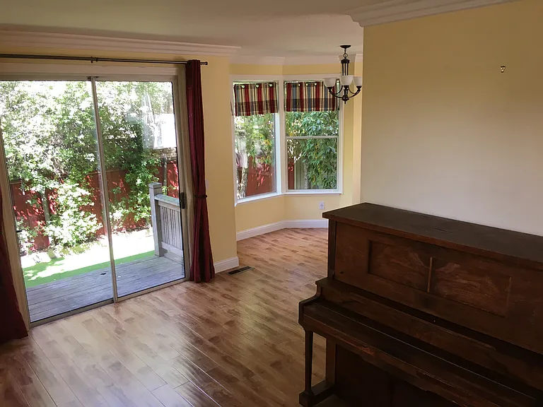 Piano included in home. Veiw into backyard.