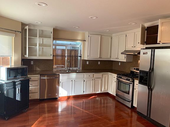 Open kitchen with newly painted cabinets and breakfast nook.