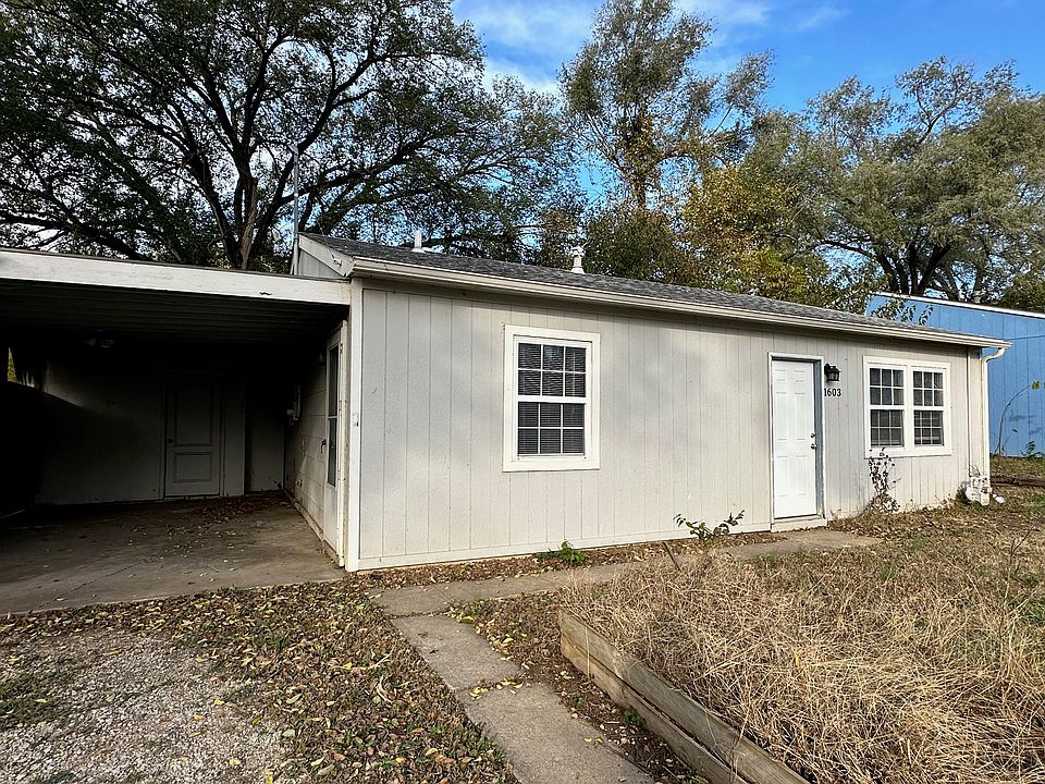 Carport with some storage and access to backyard, as well as the home.