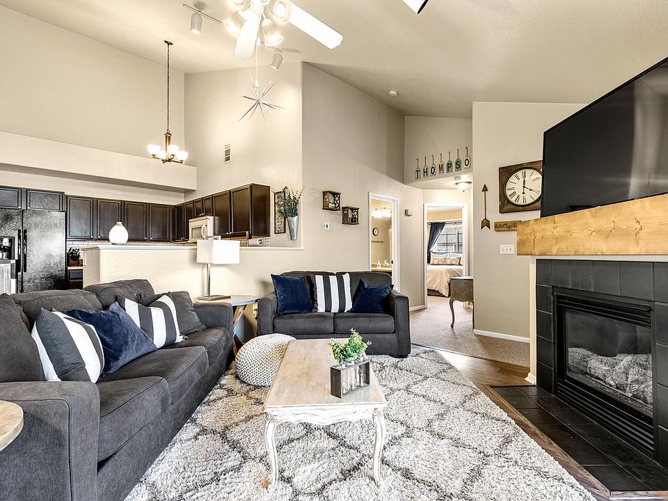 Open concept living room with gas fireplace and access to balcony.