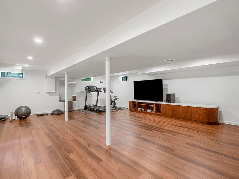 Large lower level with area for gym, recreation and relaxation.