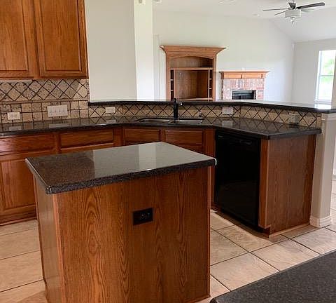 Kitchen with new dishwasher, garbage disposal and Island. Nice countertops. Opens to the living area.