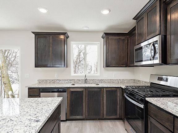 The kitchen is chef-ready with stainless steel appliances
