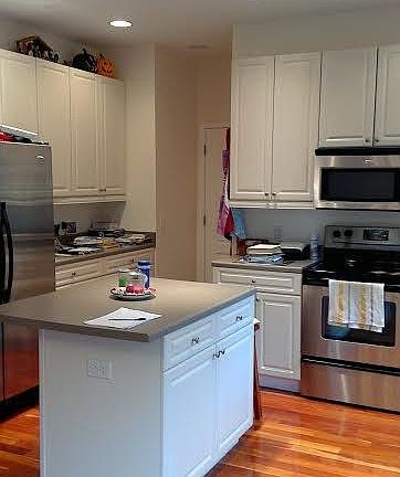 Spacious kitchen with island work station and stainless appl