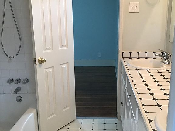 Bathroom with double sink, tub, shower.
