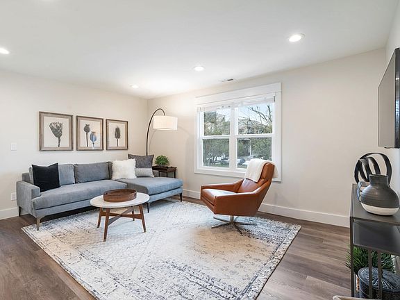 Family Room, High Speed Internet, SMART TV. High end furnishings include swivel leather chair and sectional sofa.