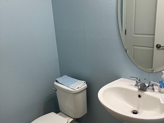 Downstairs half bath with storage closet to the left