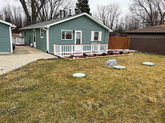 Front view of newly painted house with new roof and gutters