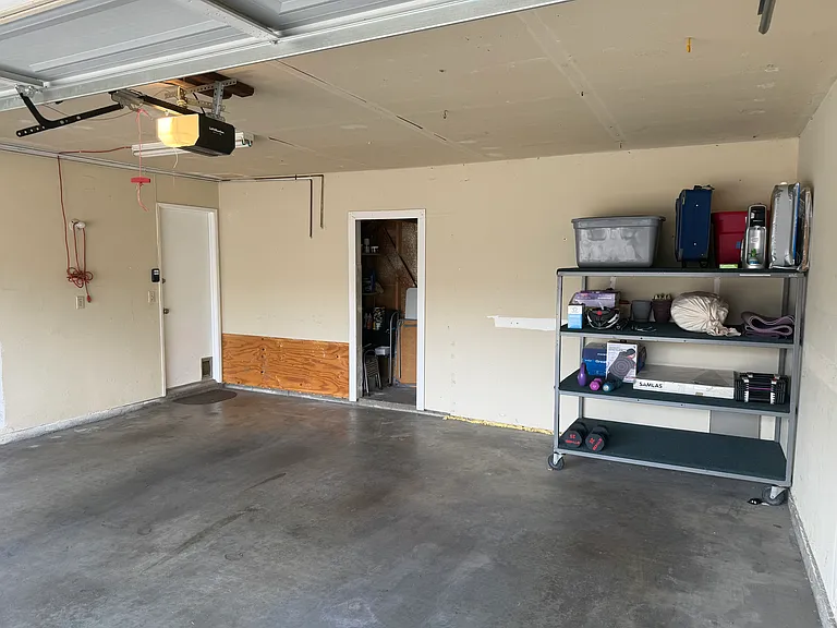 Two-car garage with washer/dryer and additional storage area. New wifi-enabled garage door opener.