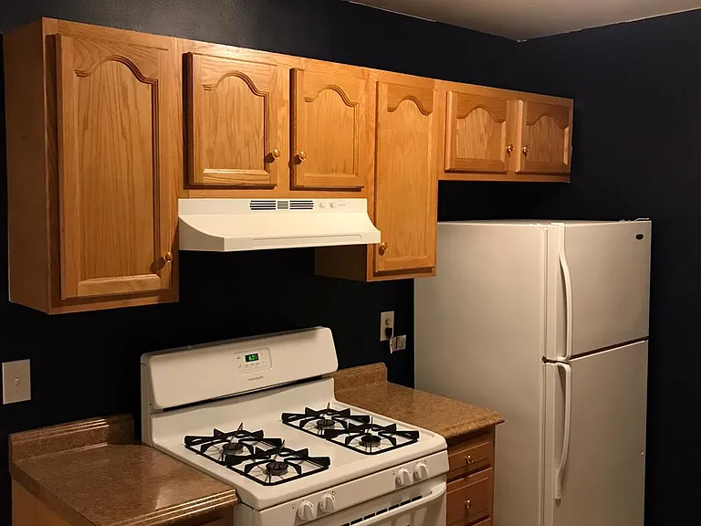 Galley kitchen with gas stove.