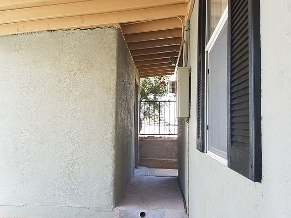 Carport view of storage shed