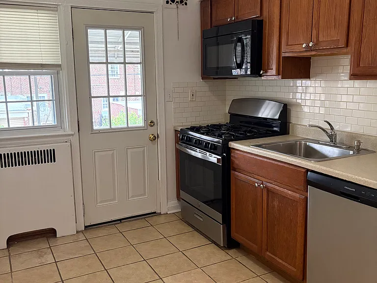Kitchen with door leading to covered Rear Porch