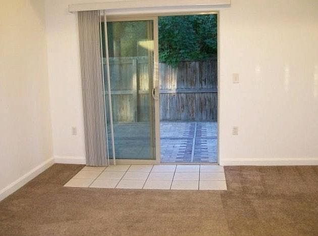 Patio doors connect family room to a cute garden.