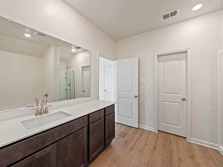 The master bathroom has a large vanity space.