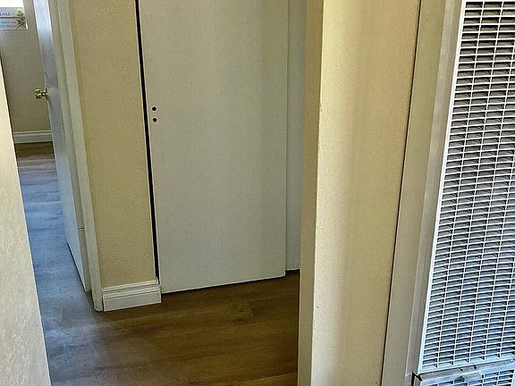 looking into hall and bedroom from living room, laminate in living, hall and both bedrooms