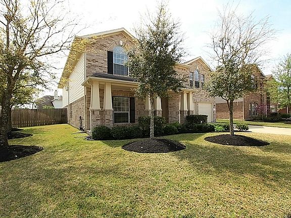 Another view of the impressive front lawn highlighting the five oak trees and double wide driveway to accommodate additional parking.