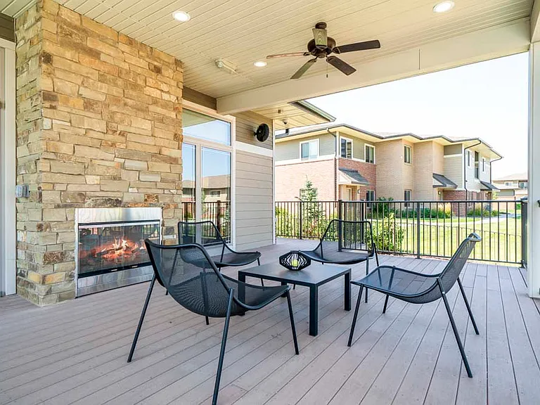 Our clubhouse features a covered patio with a fireplace and seating area.