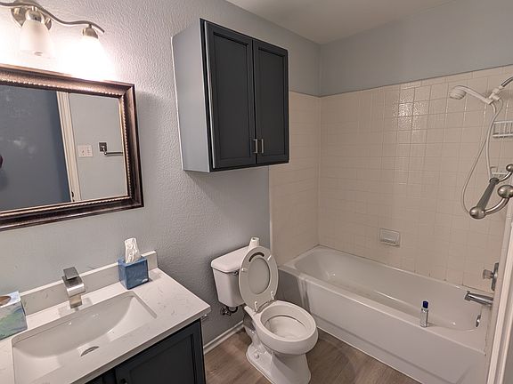 Common / guest bathroom with new LVP flooring, freshly painted cabinets with quartz countertop and new faucets