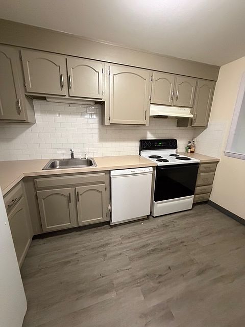 Updated kitchen with hw laminate flooring, opens up to a nice sized dining area with window opening up to livingroom and private balcony.