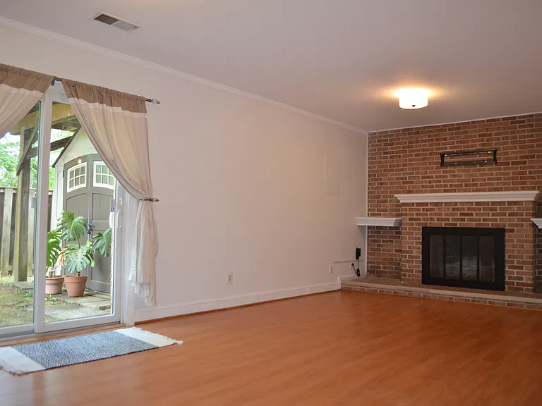 The walk-out basement opens to a fenced-in yard with a shed for storage.