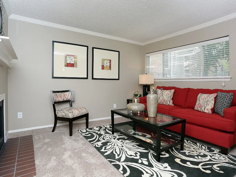Spacious open-concept living room with large windows and natural light