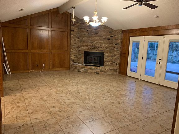 Large Living Room with Fireplace with nice view of pool and patio.