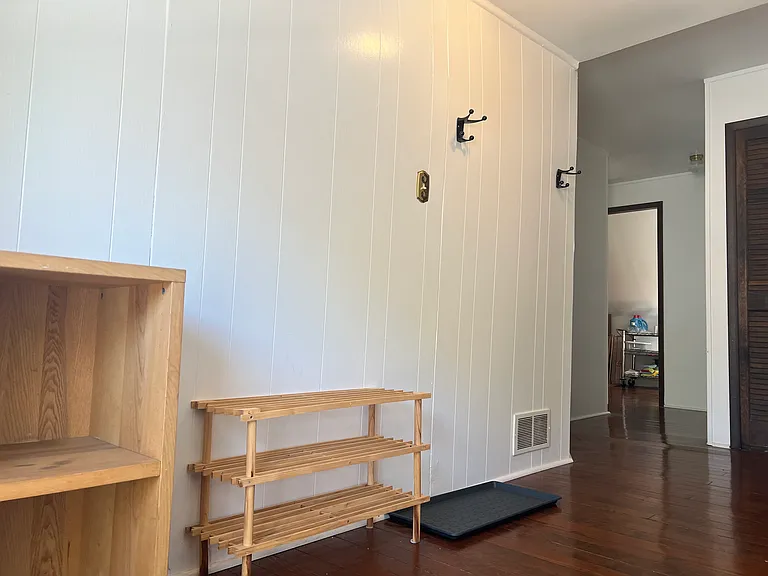 Entry to living area of apartment at the top of third floor staircase.