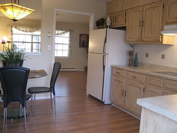 Kitchen Looking into Living Room with Wood Laminate Flooring All Freshly Paint