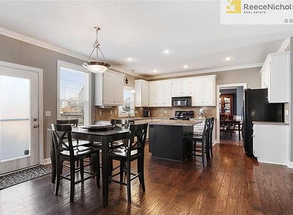 Beautiful hardwoods & white cabinets in bright open Kitchen