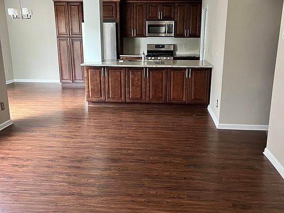 Tastefully Renovated unit. View from foyer with Vaulted ceilings.