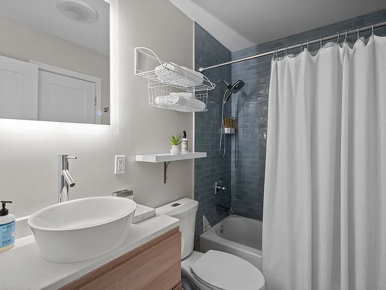 Back lit mirror, available shelving, lots of towel hooks and soaps dispenser.