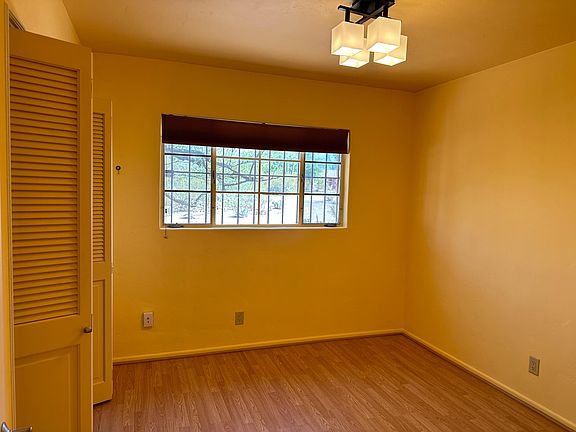 Bedroom 1: full bedroom with large hanging closet (7.5 ft), view to the north. Approx 10x10.