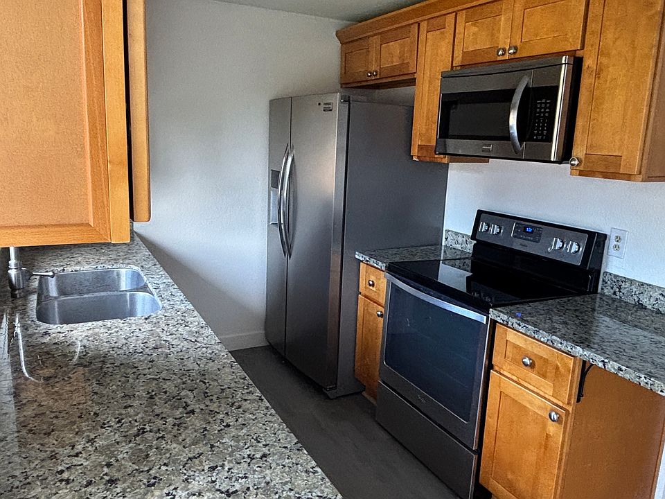 Fully updated kitchen with glass-top stove, double-door fridge, microwave, and dishwasher