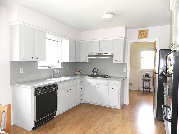 Light kitchen  with wood tone floors