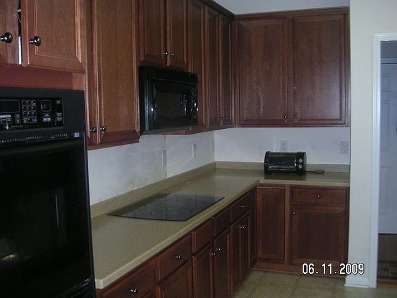gourmet kitchen with glass cook top and two owens