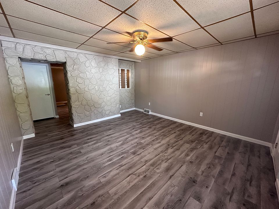 Living Room with new flooring, paint, outlets and ceiling fan.