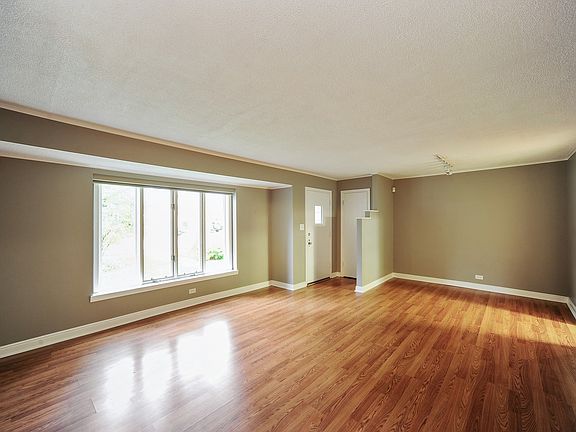 Combination living/dining room with large picture window 