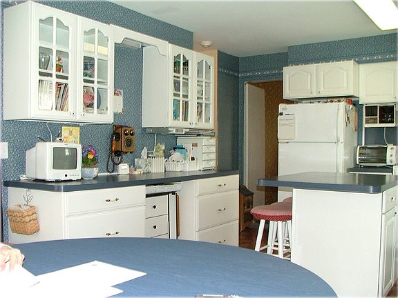 Abundant, updates white cabinets, some glass doors, desk, breakfast bar.