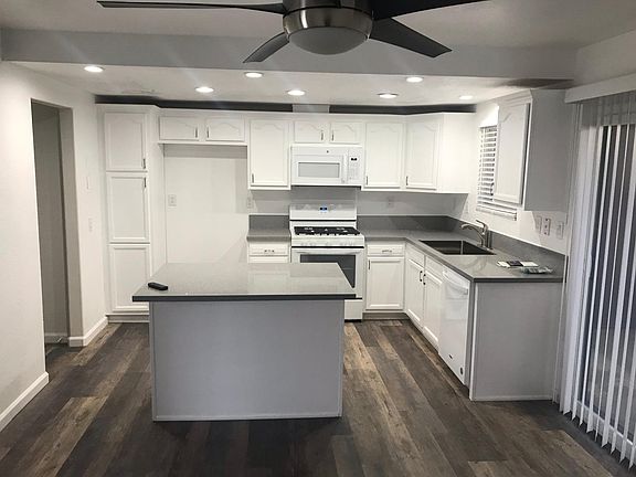 Kitchen & Dining/Entertaining Area to Right of Entrance; Fully Remodeled: New Granite Counters, Flooring, Cabinetry, Appliances, Lighting & Paint