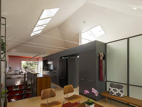 Directly accessed from the front door, the Living Room includes a coat closet, is separated from the second bedroom with an adaptable glass partition, and is open to the kitchen. Skylights above.