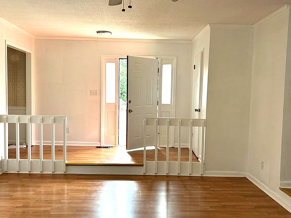 Foyer leads to a beautiful sunken living room space.